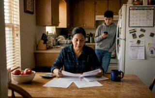 Texas mother reviewing life insurance papers at kitchen table