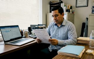 Texas small business owner reviews insurance papers
