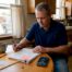 Homeowner reviewing storm insurance paperwork | Hettler Insurance Agency, Lubbock Texas, call phone 8067987800