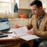 Texas contractor reviewing insurance documents at kitchen table